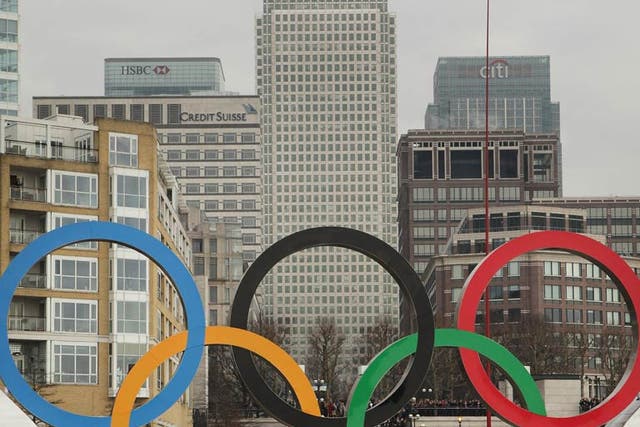 The Olympic rings pass Canary Wharf yesterday