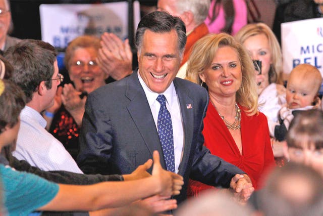 Mitt Romney, with his wife Ann, shakes hands with supporters in Novi, Michigan