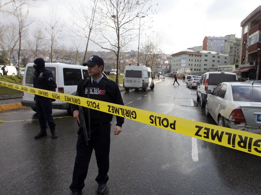 Police officers stand guard at the scene where the bomb explosion took place in Istanbul