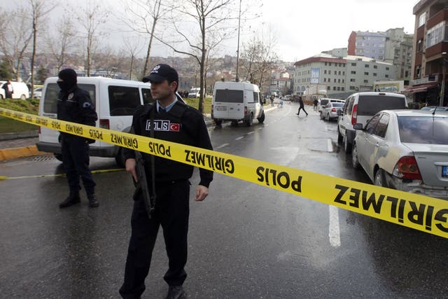Police officers stand guard at the scene where the bomb explosion took place in Istanbul