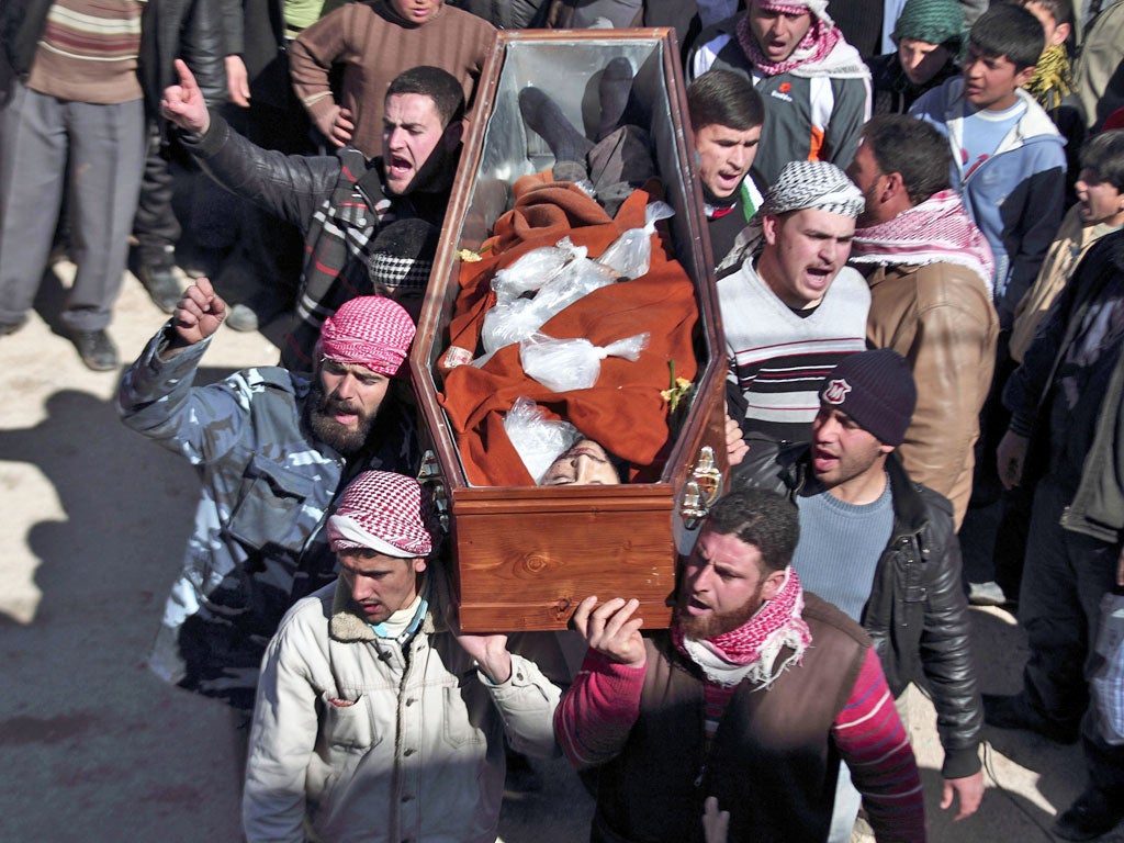 Men carry the coffin of a member of the Free Syrian Army near the northern city of Idlib