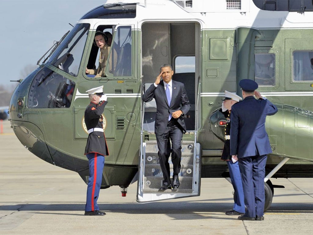 Barack Obama salutes as he steps off Marine One at Andrews Air Force Base in Maryland yesterday