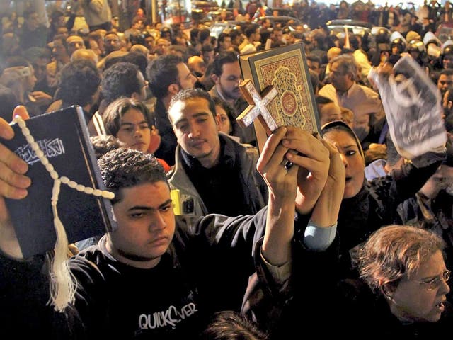 Muslims and Christians protest against an attack on
a Coptic church