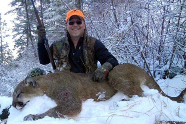Dan Richards, of Upland, president of the California Fish and Game Commission, shows off a mountain lion he shot during a recent hunting trip to Idaho.