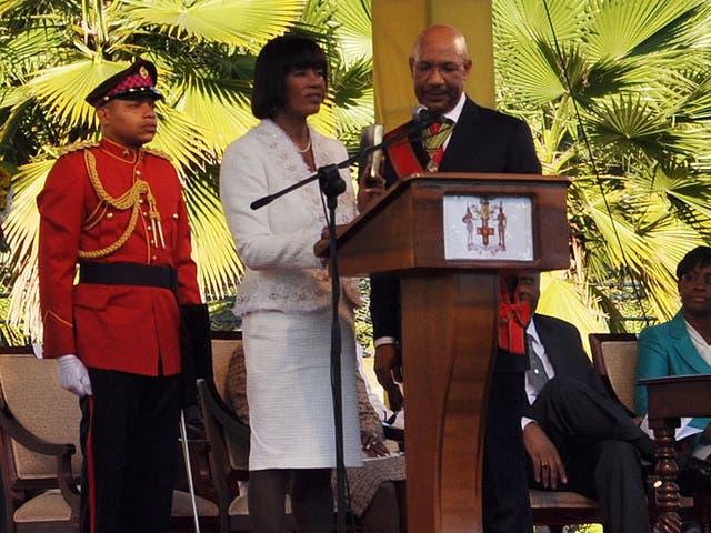 People's National Party leader Portia Simpson Miller (2nd-L) takes the oath of office in January