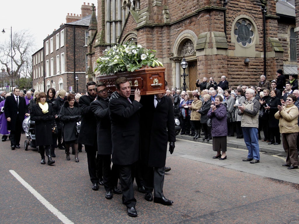 Friends and Family carry the coffin of comedian Frank Carson through the streets of Belfast after a funeral mass at St Patrick's Catholic Church