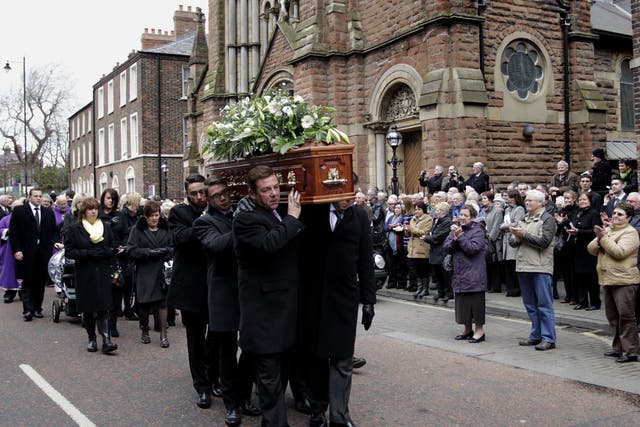 Friends and Family carry the coffin of comedian Frank Carson through the streets of Belfast after a funeral mass at St Patrick's Catholic Church