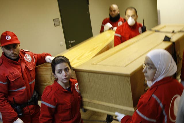 Coffins containing the bodies of Marie Colvin and photographer Remi Ochlik
