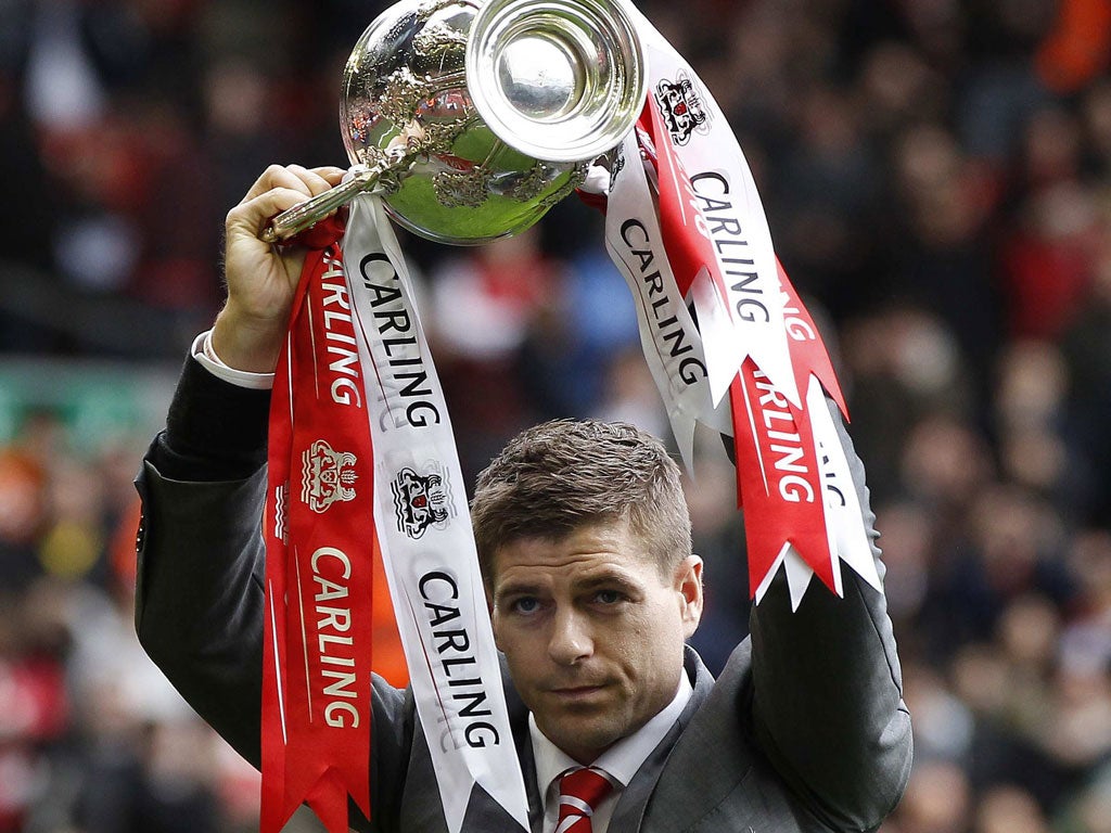 Steven Gerrard looks rather bashful as he shows off the Carling Cup