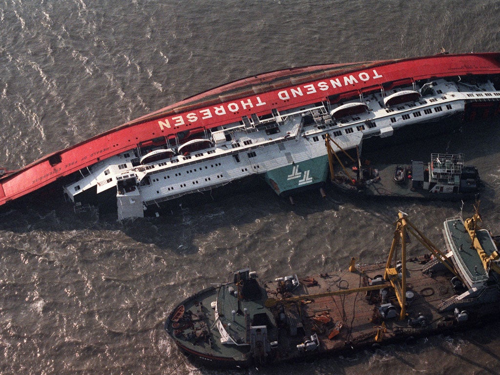 Boats attend the Herald of Free Enterprise the day after the disaster in March 1987. The bow doors had been left open as she left the Belgian port; she capsized so quickly there was no time to send an SOS