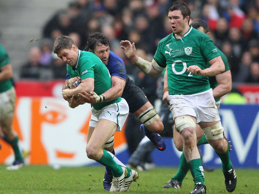 Ronan O'Gara of Ireland is tackled by Lionel Nallet