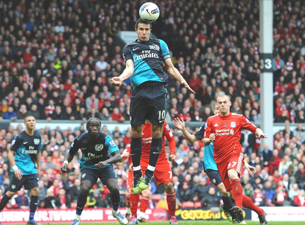 Robin van Persie, whose two goals settled the game, gets
ahead for Arsenal at Liverpool