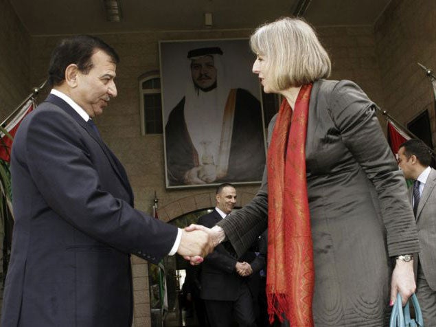Jordan's Interior Minister Mohammad Al Raod shakes hands with Theresa May after their meeting in Amman