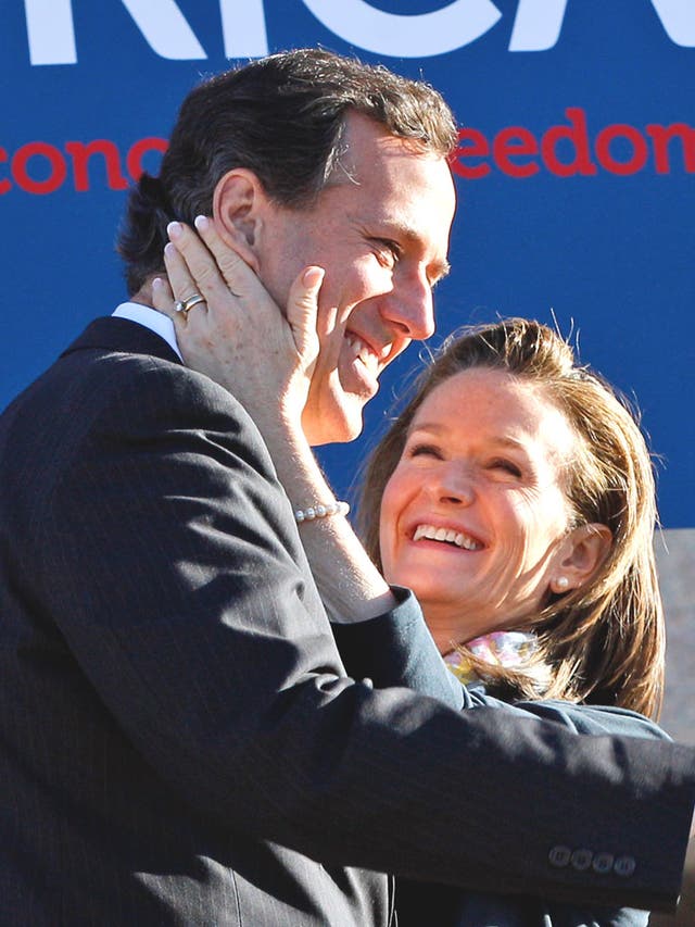 Rick Santorum is hugged by his wife Karenafter speaking at a rally in Oklahoma City