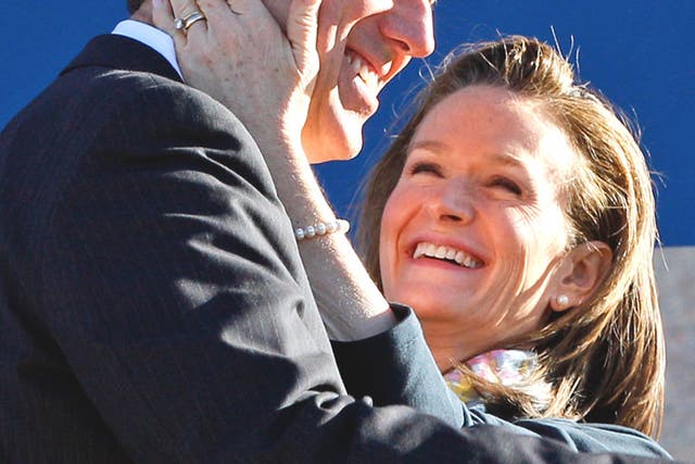 Rick Santorum is hugged by his wife Karenafter speaking at a rally in Oklahoma City