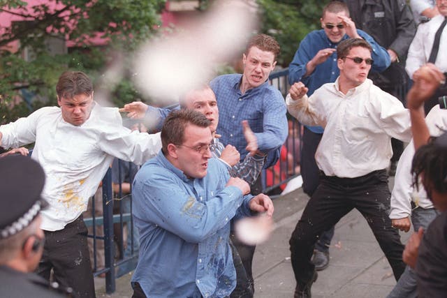 Luke Knight (left), Neil Acourt (second left), David Norris (centre back, wearing blue shirt), Jamie Acourt (white shirt, throwing punch) and supporters are pelted with eggs on 30 June 1998 after giving evidence to the Macpherson public inquiry into the police handling of the Stephen Lawrence murder case