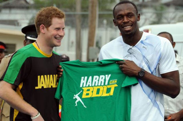 Prince Harry receives a T-shirt as a gift from Olympic sprint champion Usain Bolt 