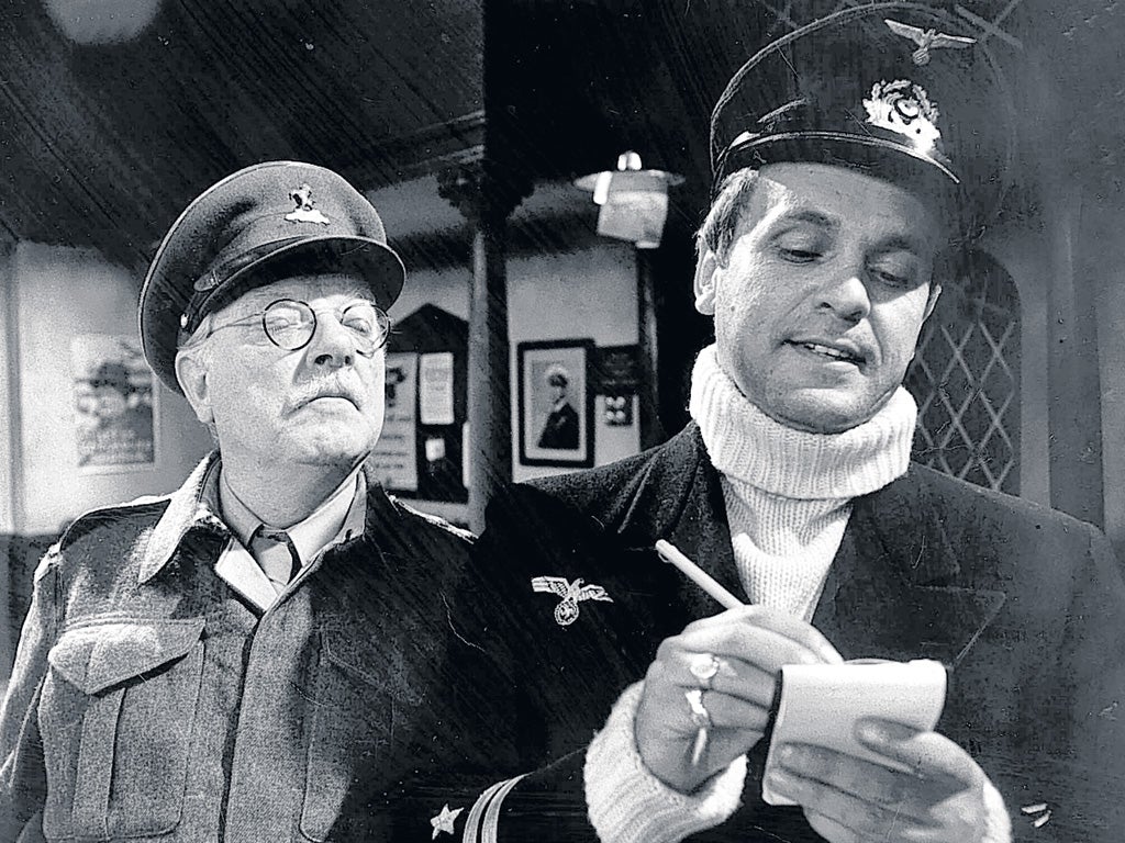 Arthur Lowe as Captain Mainwaring looks on as Madoc's U-boat captain takes down Pike's name in 'Dad's Army'