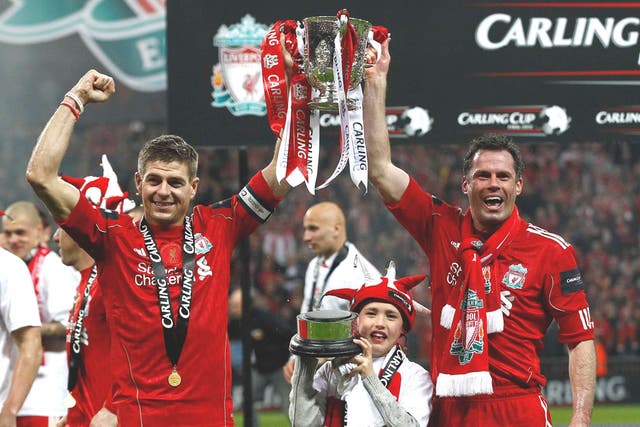Jamie Carragher (right) celebrates the Carling Cup final victory with
fellow Liverpool stalwart Steven Gerrard last month