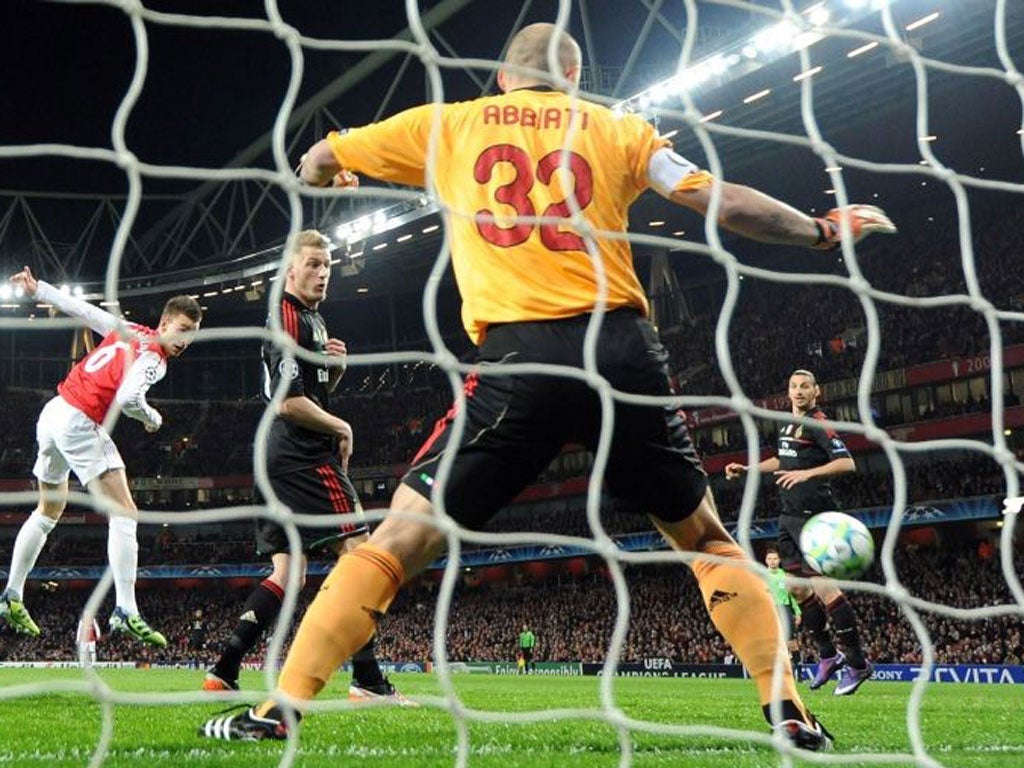 Laurent Koscielny scores Arsenal's first goal during the Champions League match against AC Milan