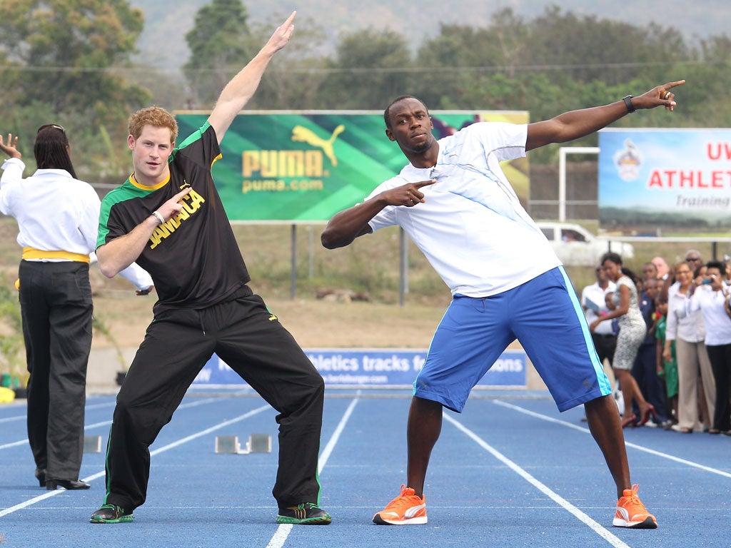 Prince Harry tries to imitate Usain Bolt’s victory celebrations during a visit to Jamaica yesterday