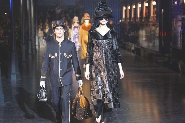Models wear creations by Marc Jacobs as part of his autumn/winter collection for Louis Vuitton in Paris where the audience was greeted with a spectacular life-size train