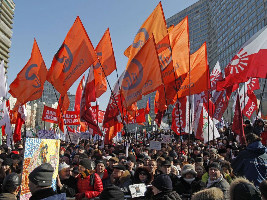 Opposition protesters with their flags gathered in the centre of Moscow to rally against electoral fraud.