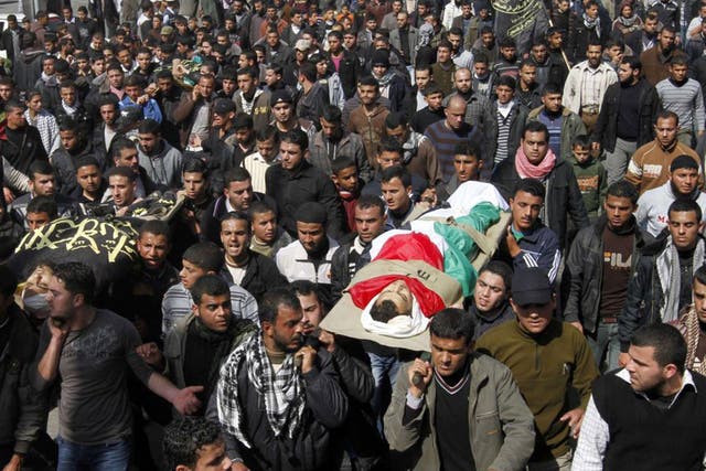 Palestinian mourners carry the bodies of seven Islamic Jihad militants, who were killed in Israeli air strikes
