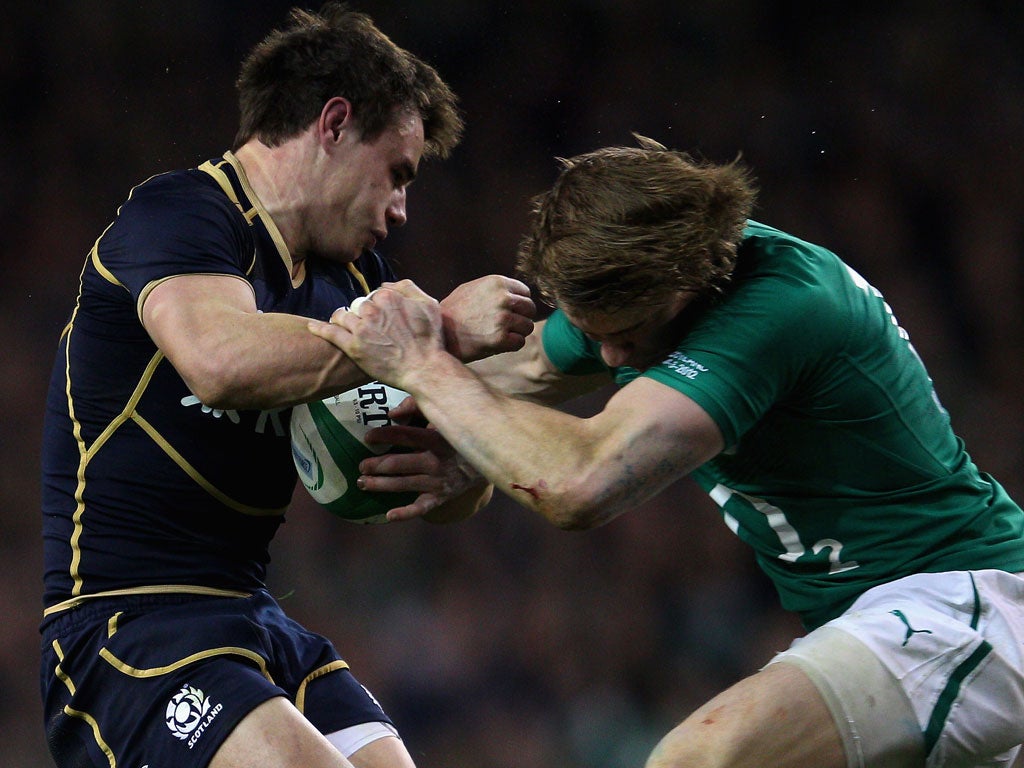 Scotland's Lee Jones is knocked out in a tackle with Ireland's Andrew Trimble