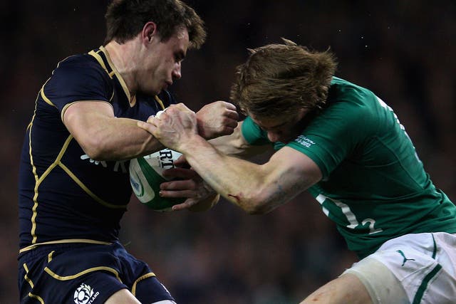 Scotland's Lee Jones is knocked out in a tackle with Ireland's Andrew Trimble