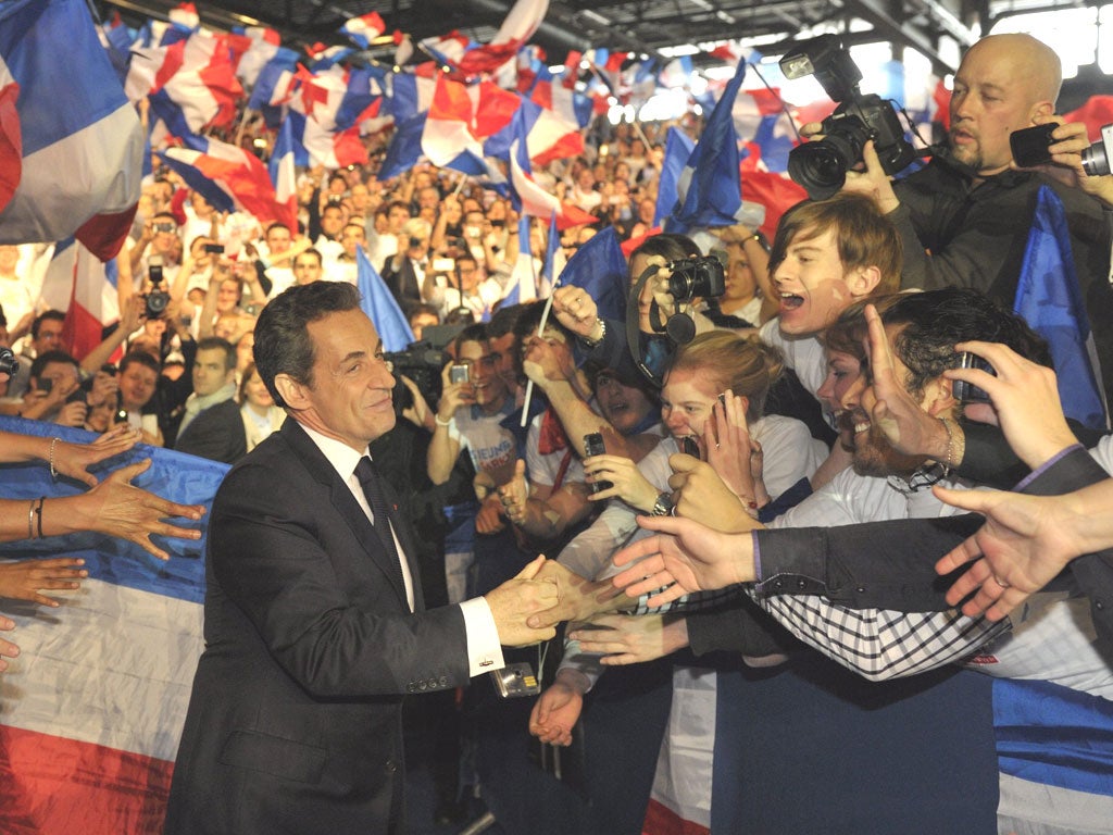 Nicolas Sarkozy is cheered by 40,000 supporters in
Villepinte yesterday as he steps up his election campaign