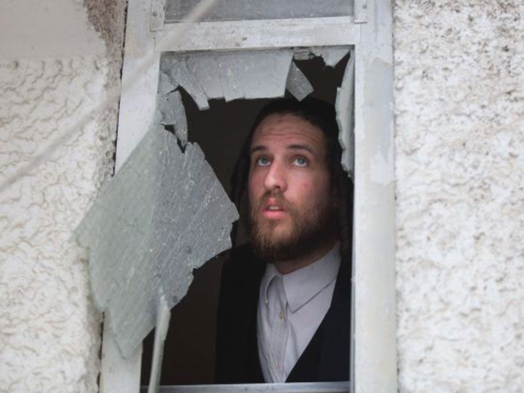 Aman surveys the damage after an air strike in Ashdod, Israel