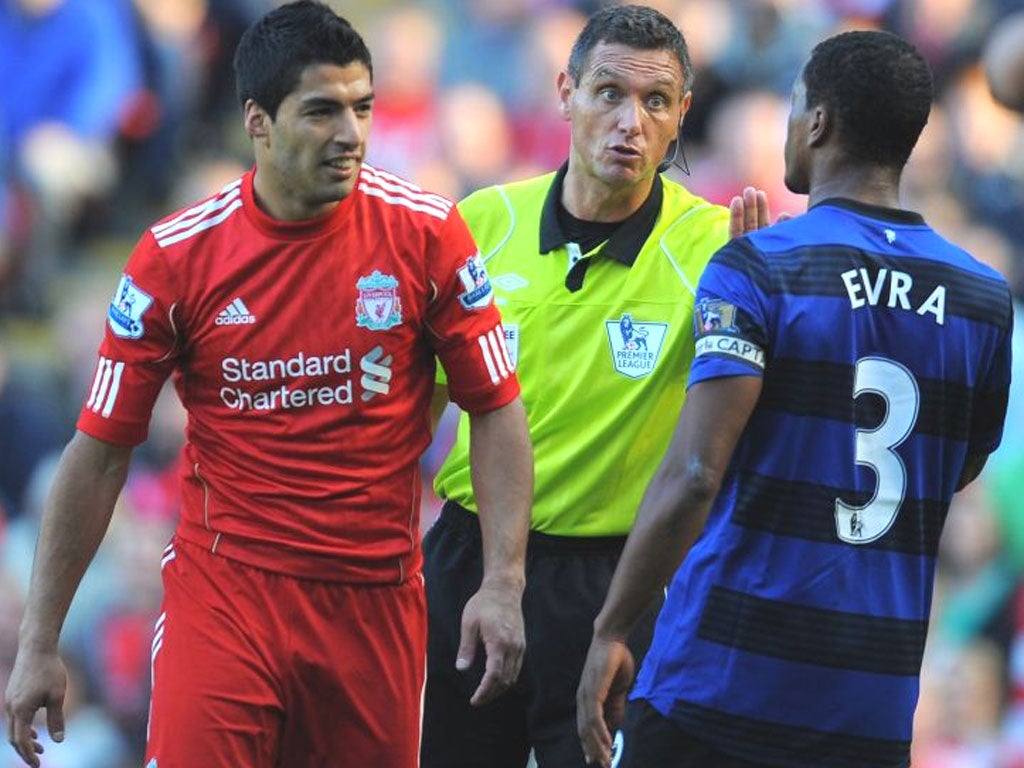 Referee Andre Marriner steps in as Suarez and Evra clash
