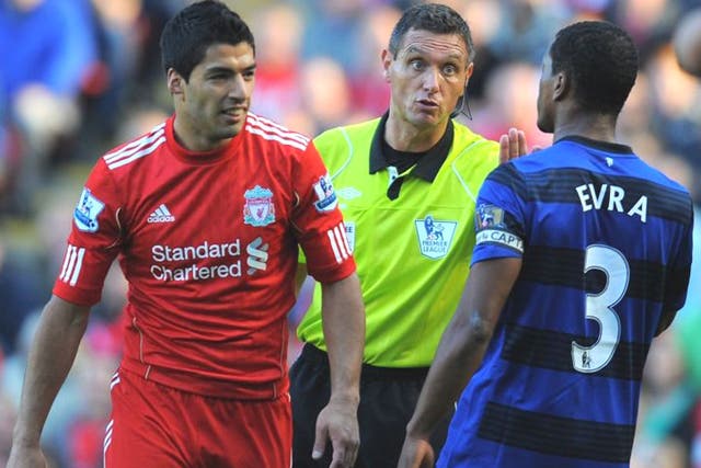 Referee Andre Marriner steps in as Suarez and Evra clash