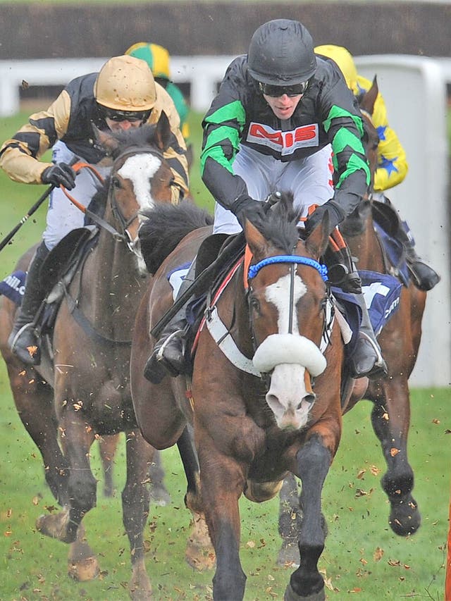 Cinders And Ashes, ridden by Jason Maguire, flattens the last flight en route to victory in the Supreme Novices' Hurdle at Cheltenham yesterday