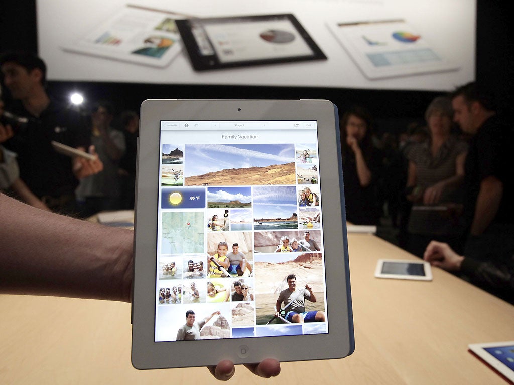 Members of the tech media try out the new iPad during a special event in San Francisco. Apple is releasing its third-generation iPad just 25 months after starting the tablet-computing revolution