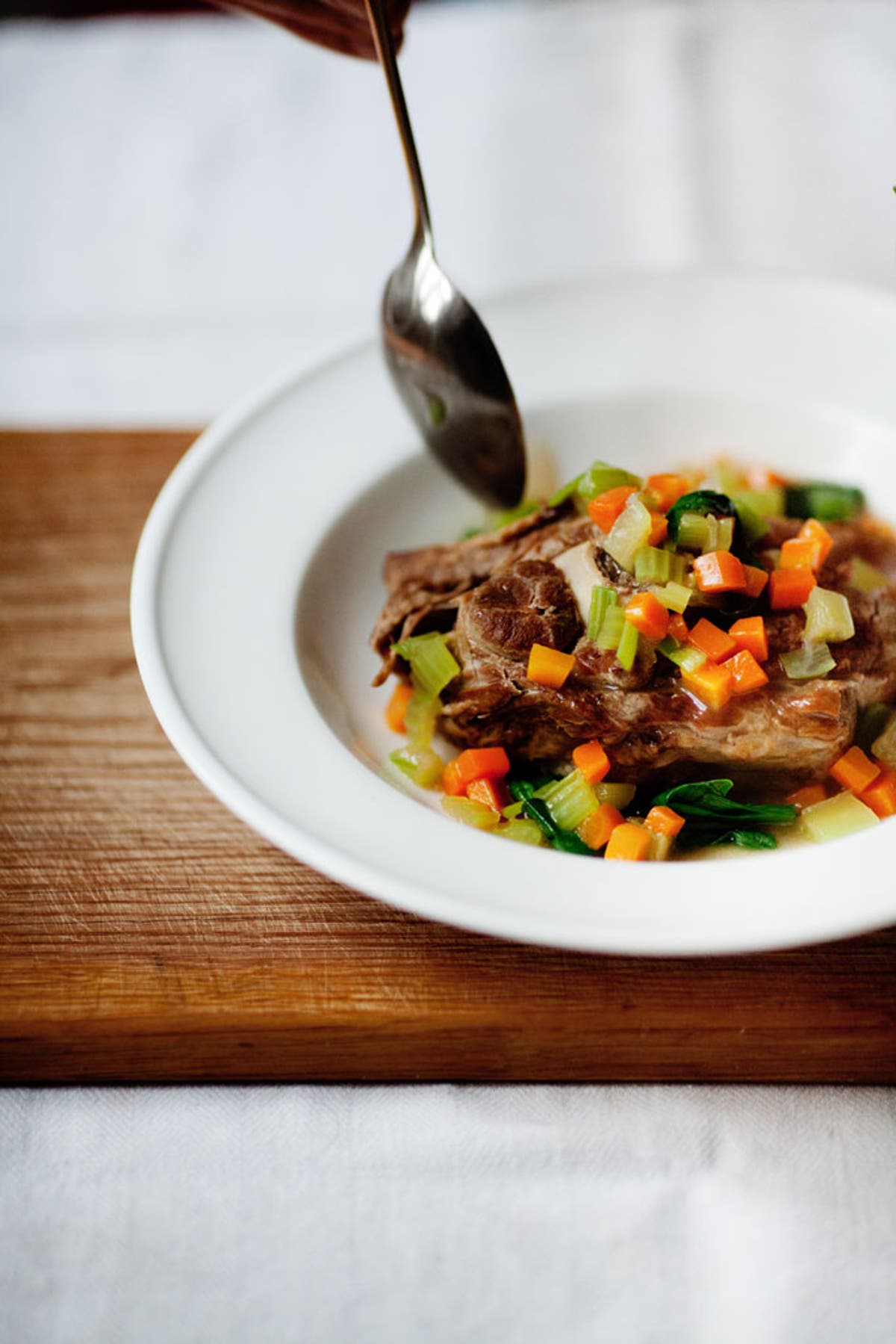 Slow-cooked mutton neck chops with root vegetables and wild garlic
