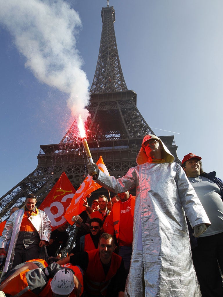 Riot police fired tear gas to disperse dozens of protesting steelworkers in Paris yesterday