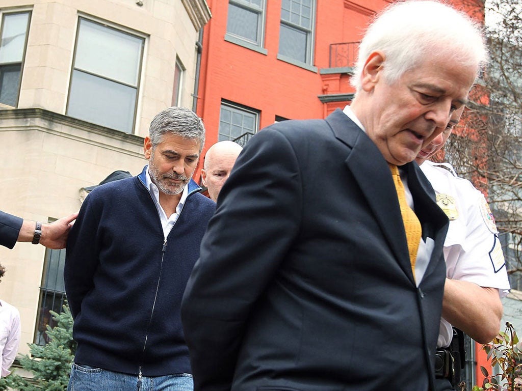 George Clooney and his journalist father Nick are handcuffed by officers of the US Secret Service's uniformed division