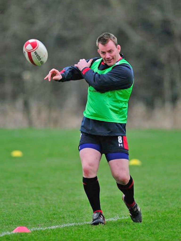 Matthew Rees flings a pass during training yesterday