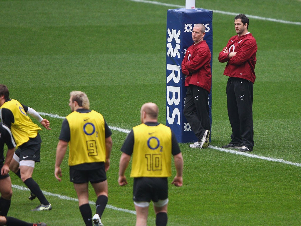 Stuart Lancaster (second right) and Andy Farrell watch England
training at Twickenham