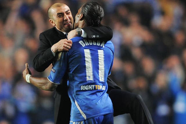 Chelsea manager Roberto Di Matteo enjoys the defeat of Napoli with Didier Drogba