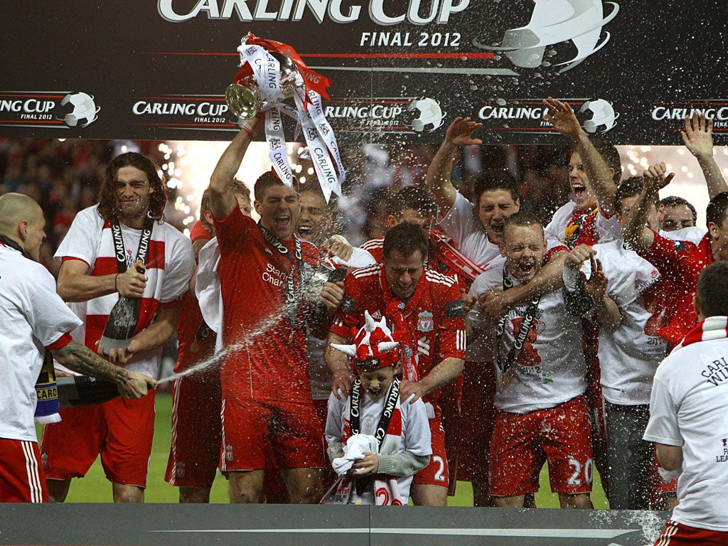 Champagne moment: Liverpool's captain, Steven Gerrard, leads the celebrations after they defeated the Championship side Cardiff City in the Carling Cup final thanks to a penalty shoot-out to win their first trophy in six years
