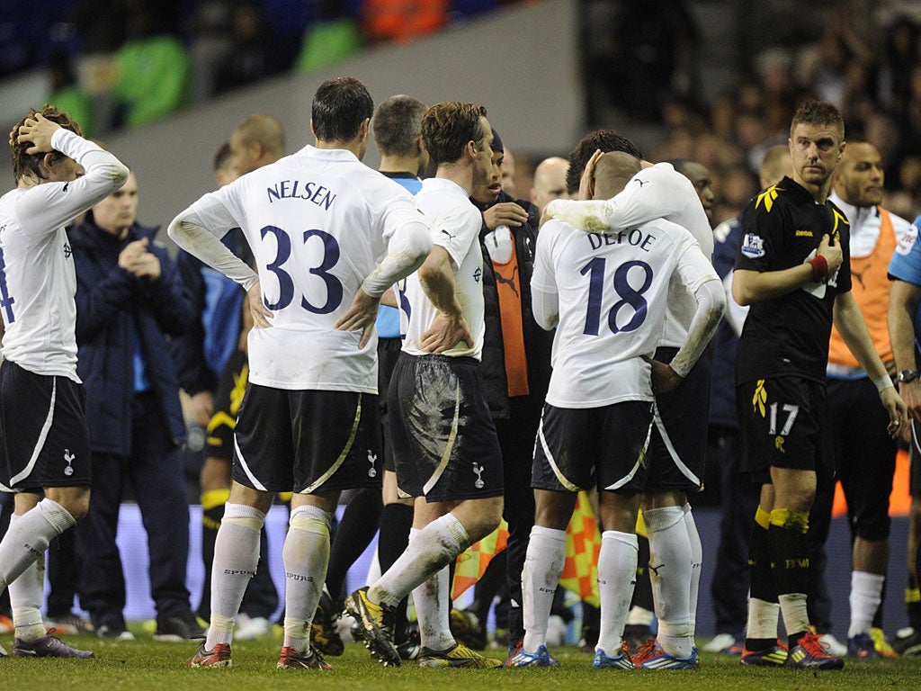 Tottenham Hotspur's Jermain Defoe, Ryan Nelsen and Luka Modric react after Bolton Wanderers' Fabrice Muamba is carried off on a stretcher