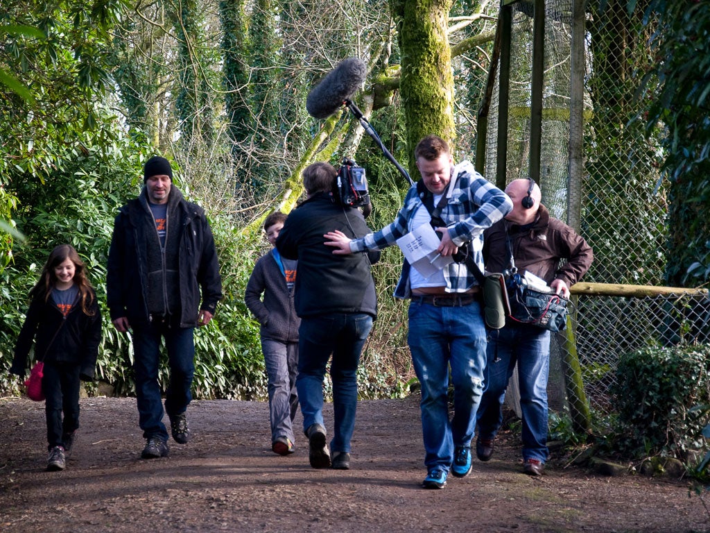 Benjamin Mee with a television crew filming him and his children, Milo and Ella