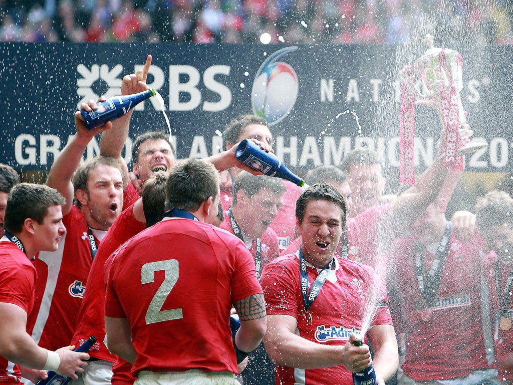 Wales toast their Grand Slam achievement after beating France in Cardiff yesterday