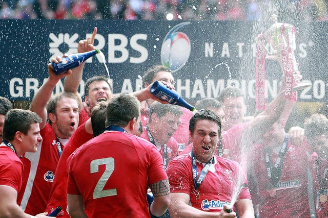 Wales toast their Grand Slam achievement after beating France in Cardiff yesterday