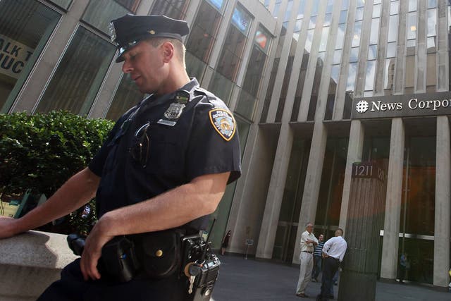 On Watch: A police officer outside News Corporation's HQ in Manhattan, New York last year