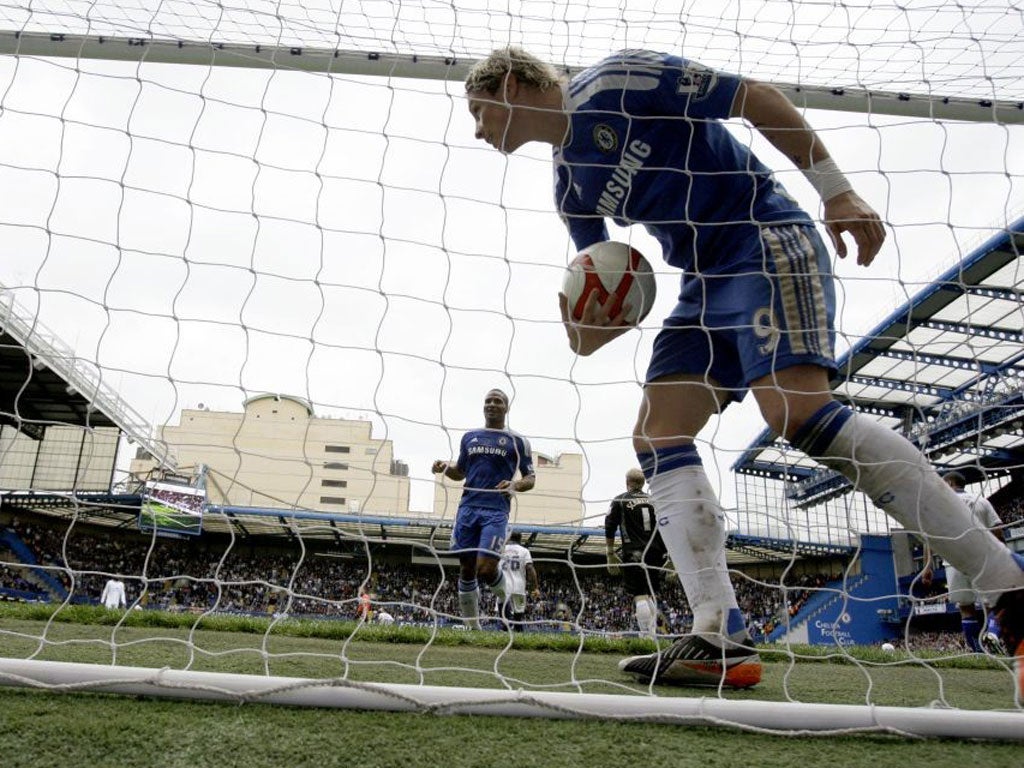 Fernando Torres retrieves the ball after scoring his first goal against Leicester