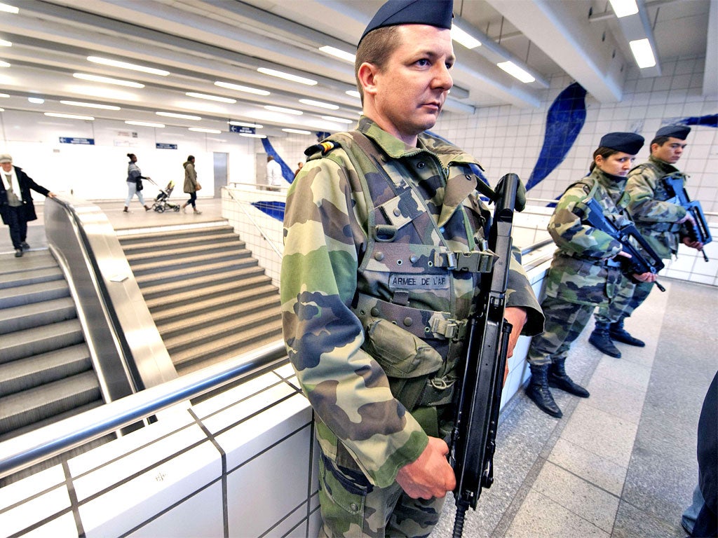 Soldiers stand guard in the subway in Toulouse after the third gun attack in a week